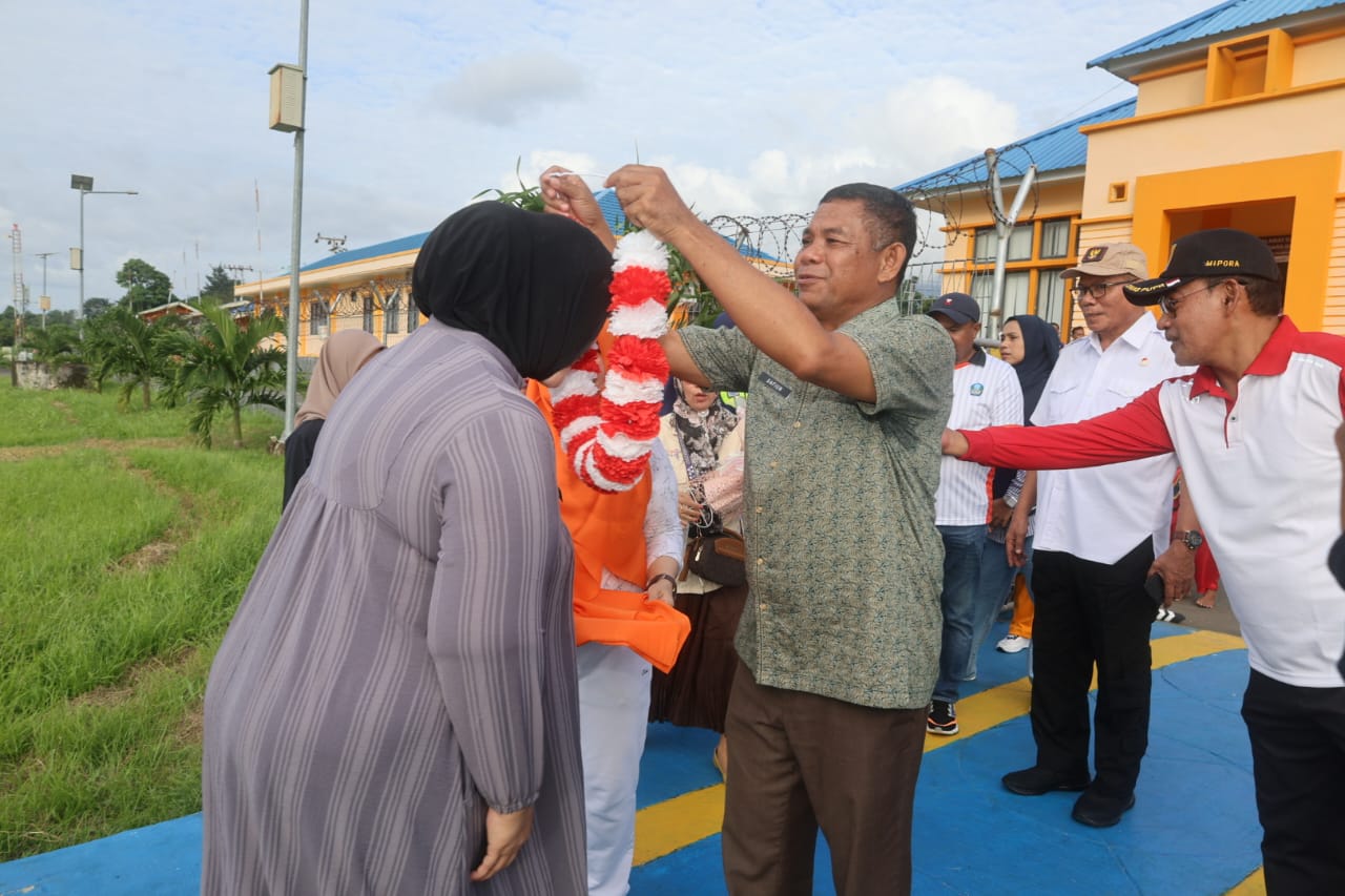 Sekda Halsel kalungkan bunga ke Heny Pora (dok_sadam)